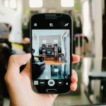 Seseorang menggunakan ponsel untuk menikmati hiburan digital
